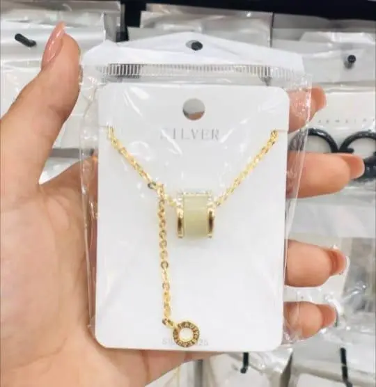 Elegant gold women's necklace with a cylindrical design and studs